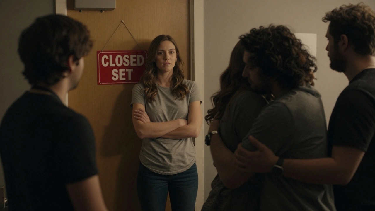 An intimacy coordinator observing a tender on-set moment from a respectful distance.