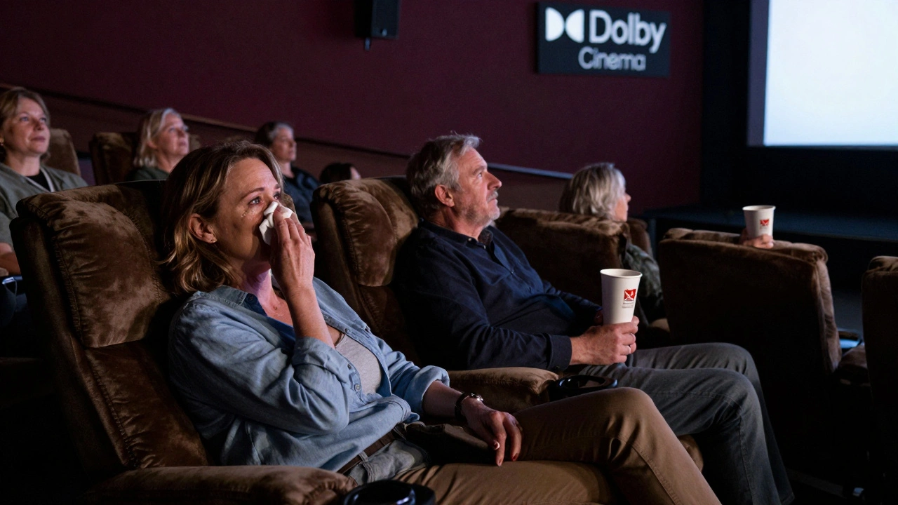 Middle-aged viewers in reclining seats quietly watching a drama, with concession cups nearby and premium cinema signage visible.