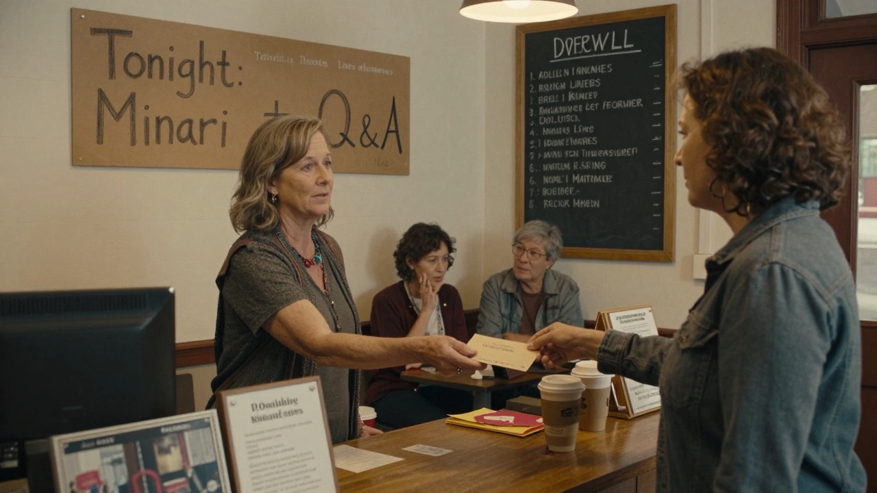 A woman donates to a small theater in Asheville, patrons chat over coffee beside a chalkboard listing indie films.