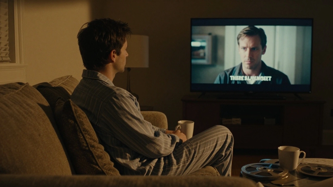 A person alone at night watching There Will Be Blood on a streaming screen, paused on Daniel Plainview’s intense stare.