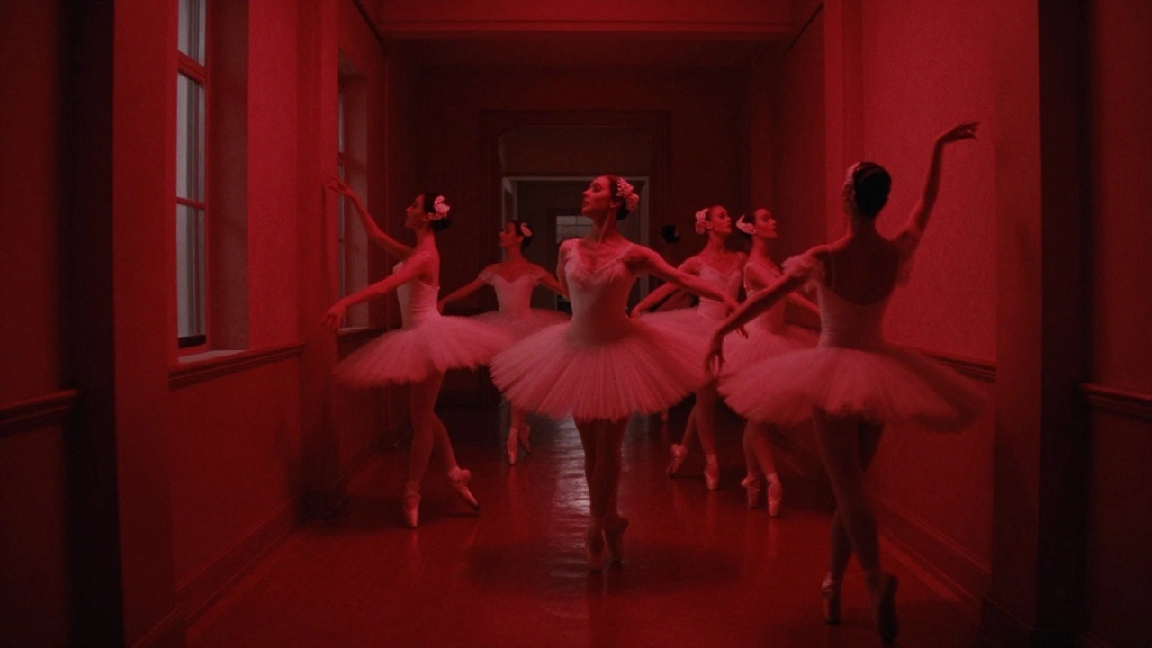 Dancers in white tutus in red-lit ballet school hallway