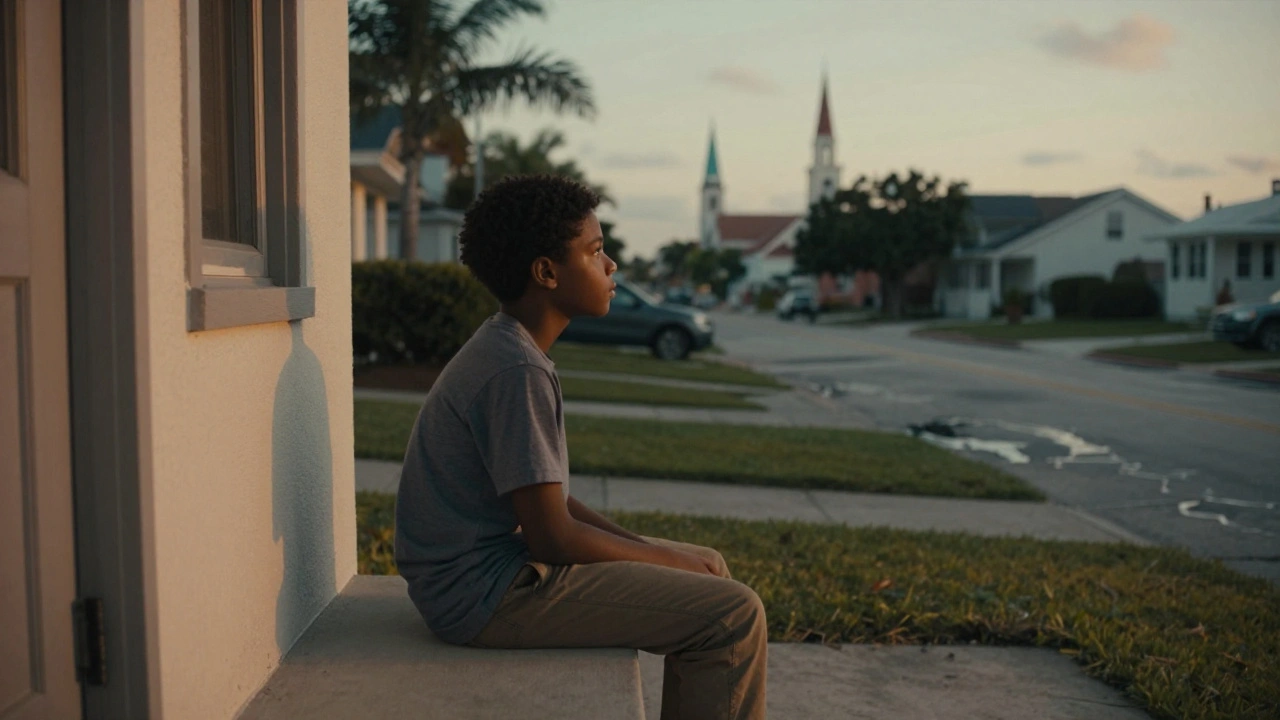 A young Black boy sits alone on a porch at dusk, reflecting the quiet beauty of 'Moonlight'.