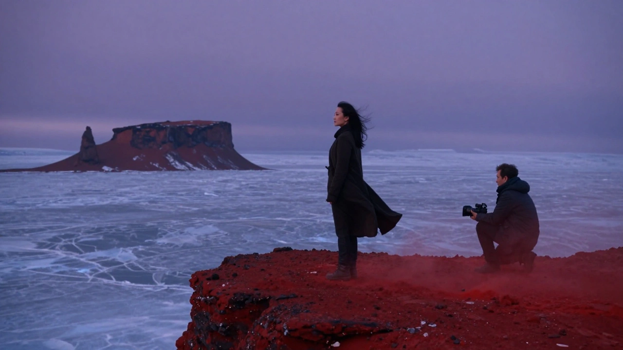 Chinese actress stands alone on a cliff in Iceland, wind sweeping her coat as Martian-like rocks loom in the distance.