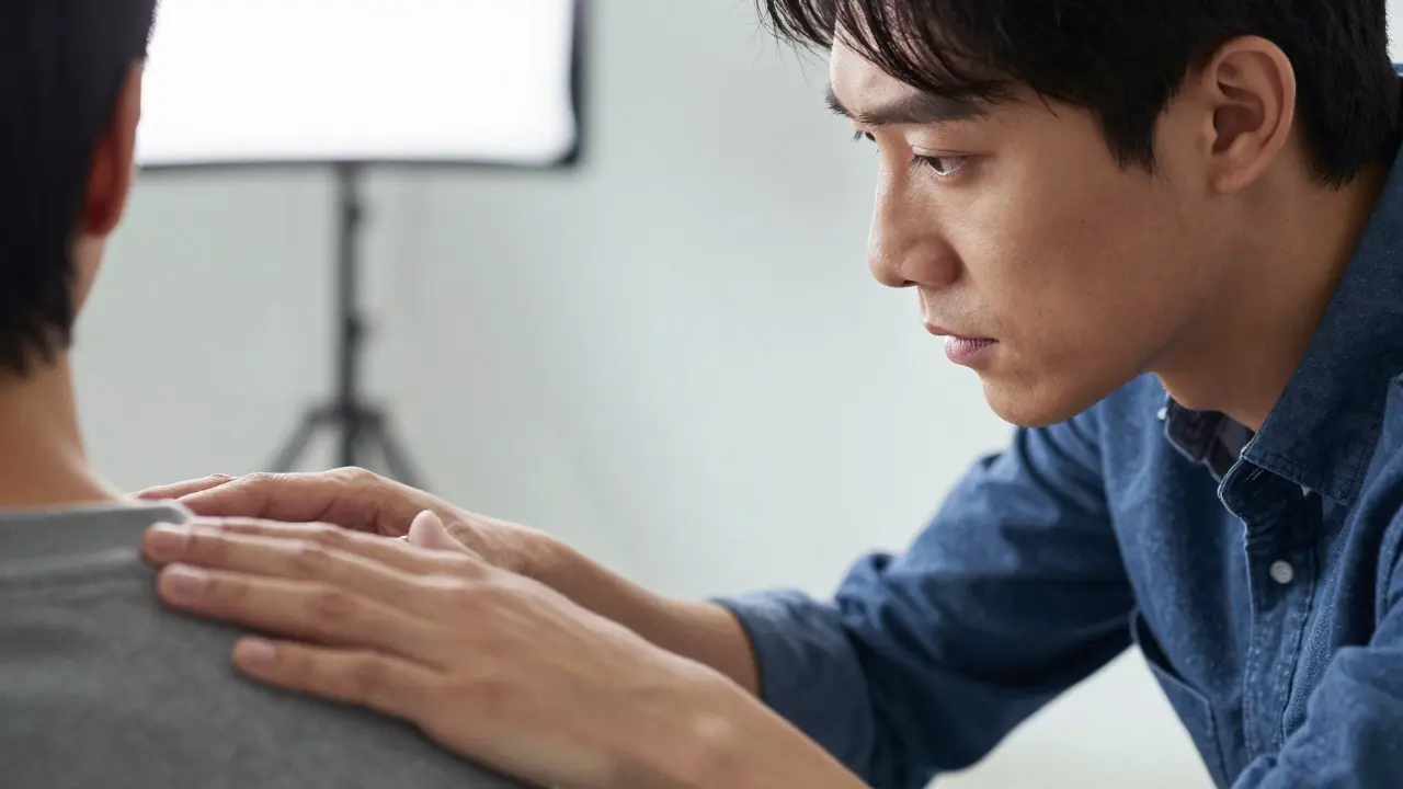 Close-up of a director and actor communicating closely during a film rehearsal